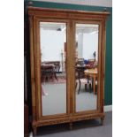 A mid-20th century French green painted parcel gilt mirrored two door armoire,