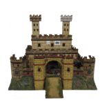 A early 20th century tinplate castle and a quantity of associated hollow cast lead soldiers,
