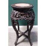 A small early 20th century Chinese carved hardwood jardiniere stand, with inset marble top,