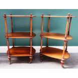 A pair of Victorian walnut shaped three tier what-nots, on turned supports,