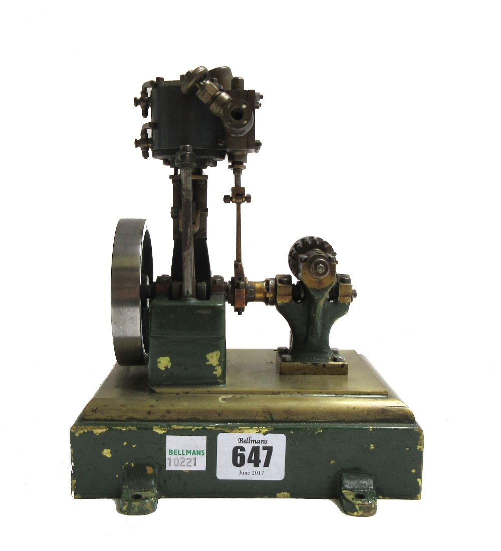 A scale model steam engine, possibly 'Stuart', with vertical piston and spoked fly wheel,