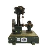 A scale model steam engine, possibly 'Stuart', with vertical piston and spoked fly wheel,