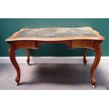 A Victorian walnut writing table, with leather inset serpentine top over a pair of frieze drawers,