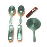 A lady's silver and green enamel mounted six piece dressing set, comprising; a hand mirror,