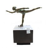 A Curtis Jere bronze skater, circa 1970, mounted atop a perspex and wooden block, signed 21cm high.