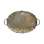 A silver twin handled shaped oval tray, length 54.5cm, Sheffield 1914, weight 1372 gms.