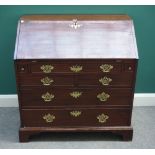 A George III mahogany bureau, the fitted interior over one long and two short drawers,