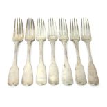 Seven Irish silver fiddle pattern table forks, comprising; six Dublin 1822 and one Dublin 1826,