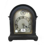 An ebonised mantel clock, mid 20th century, with silvered dial,