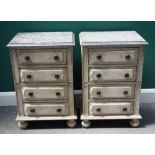 A pair of cream painted four drawer bedside tables with faux marble tops,