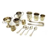 Silver, comprising; three twin handled trophy cups and a pair of sugar tongs, probably London 1819,