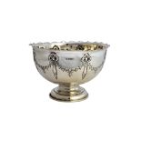 A silver centrepiece bowl, of circular form, embossed with foliate swags and linenfold drapes,