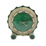 An Art Deco eight day alabaster mantel timepiece of circular shaped form,