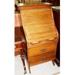 An early 20th century oak tambour front writing desk, with two drawer base, 60cm wide.