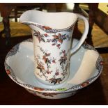 A Burleigh wash bowl and jug decorated with black and orange flowers.