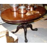 A Victorian mahogany oval snap top loo table, on four carved supports, 121cm x 89cm.