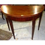 A George III mahogany fold over tea table on tapering supports. 91cm wide.