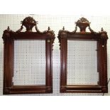 A pair of profusely carved mahogany frames with urn and swag finials,