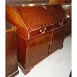 A George III mahogany bureau, with fitted interior over two drawers and two cupboards, 115cm wide.