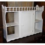 An early 20th century white painted wall shelf, with single cupboard, 76cm wide.