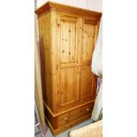 A 20th century pine wardrobe, with pair of cupboards and single drawer, 89cm wide.