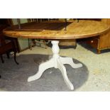 A 20th century pine extending dining table with white painted base, 108cm wide.