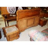 A 20th century oak bed with integral cupboards. 252cm wide.