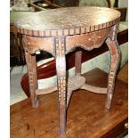An oval inlaid specimen wood occasional table. 52cm wide.