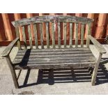 A 20th century teak slatted garden bench.