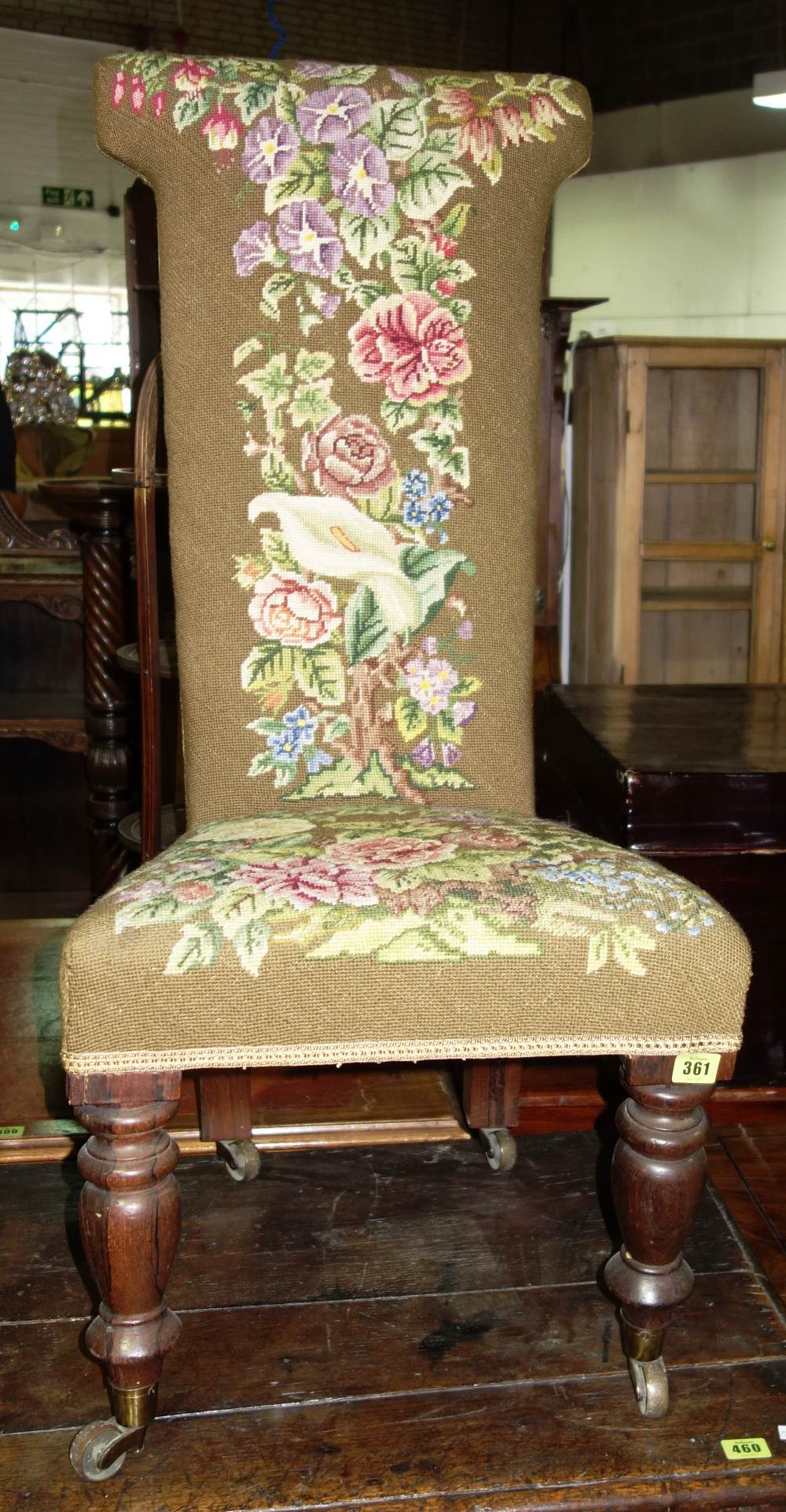 A 19th century rosewood framed needlework upholstered prie-dieu.