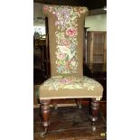 A 19th century rosewood framed needlework upholstered prie-dieu.