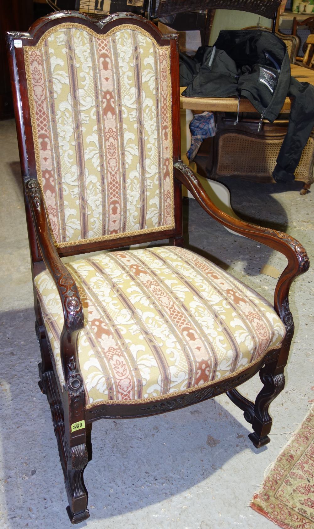 A pair of 19th century mahogany framed upholstered open armchairs.