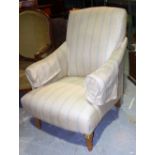 A 20th century oak framed, cream and blue striped upholstered armchair.