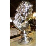 A 20th century silvered resin bust of a female. 74cm tall.