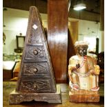 An Eastern polychrome wooden figure and a small hardwood triangular three drawer chest.