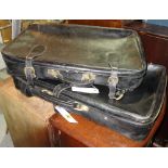 Two black leather suitcases with straps, the larger 73cm wide, (2). Property from the estate of HRH.