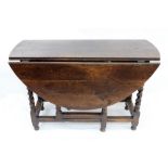 A late 17th century oak gateleg table, the hinged oval top with an end frieze drawer,