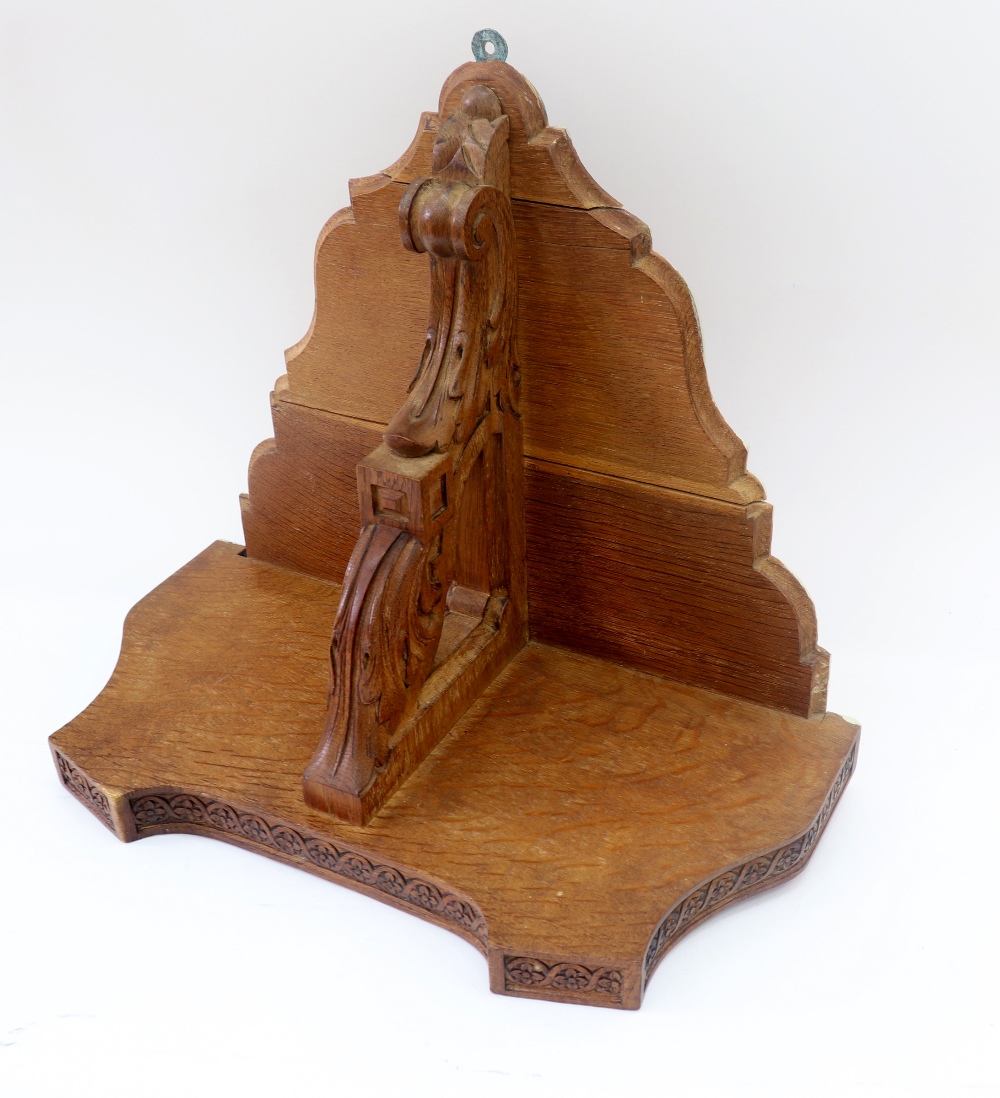 A Victorian oak clock bracket, circa 1870, of shaped outline with outset corners,