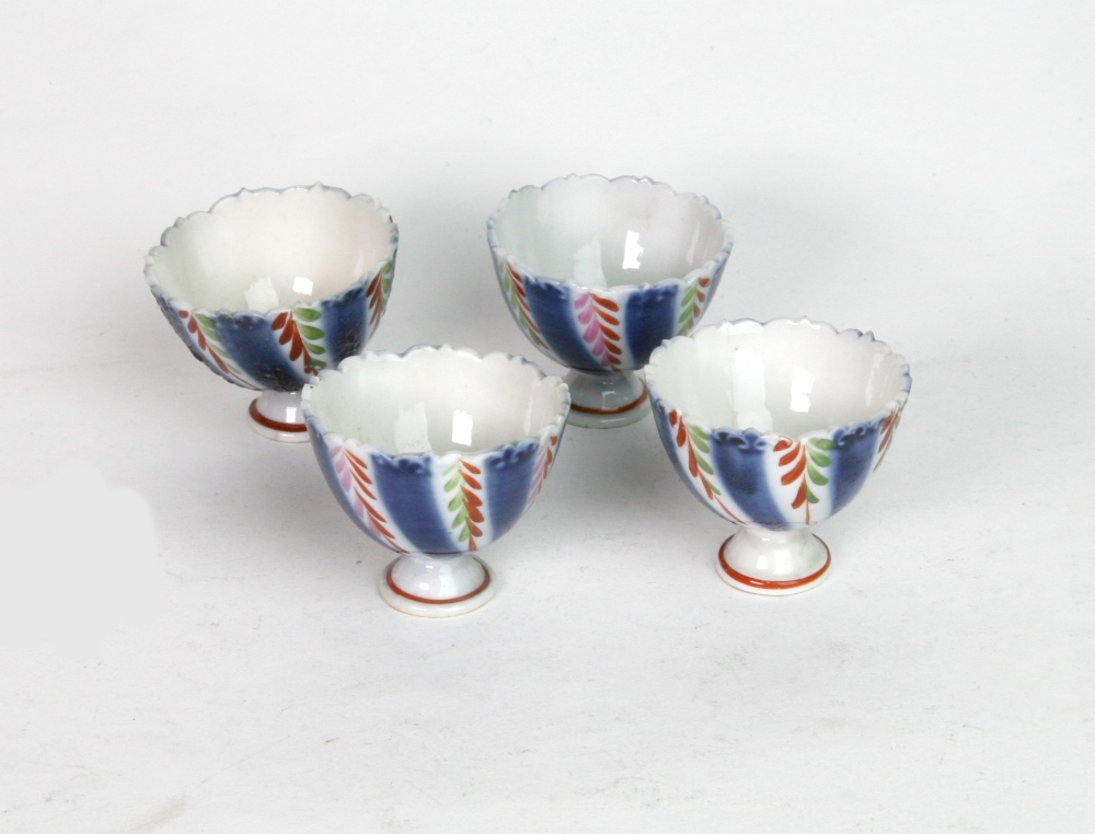 A set of four Islamic small porcelain stem cups, 19th century, painted in blue,