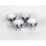 A set of four Islamic small porcelain stem cups, 19th century, painted in blue,