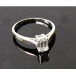 An 18ct white gold and baguette cut diamond single stone ring, the approx 0.