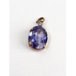 A synthetic-sapphire and small diamond pendant, the pale-blue oval mixed-cut stone weighs approx.