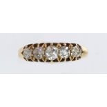 An early/mid 20th century gold and diamond five stone ring, the graduated old-cut stones approx. 2.