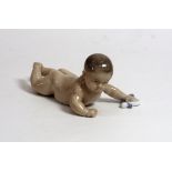 A Royal Copenhagen figure of a baby crawling, no. 1738.