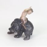 A Royal Copenhagen figure, Faun backwards on a grey bear, no. 976.