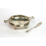 An Arts & Crafts spot hammered silver butter dish and knife, A E Jones, Birmingham 1921,