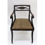 A Regency ebonised gilt metal mounted open arm elbow chair,