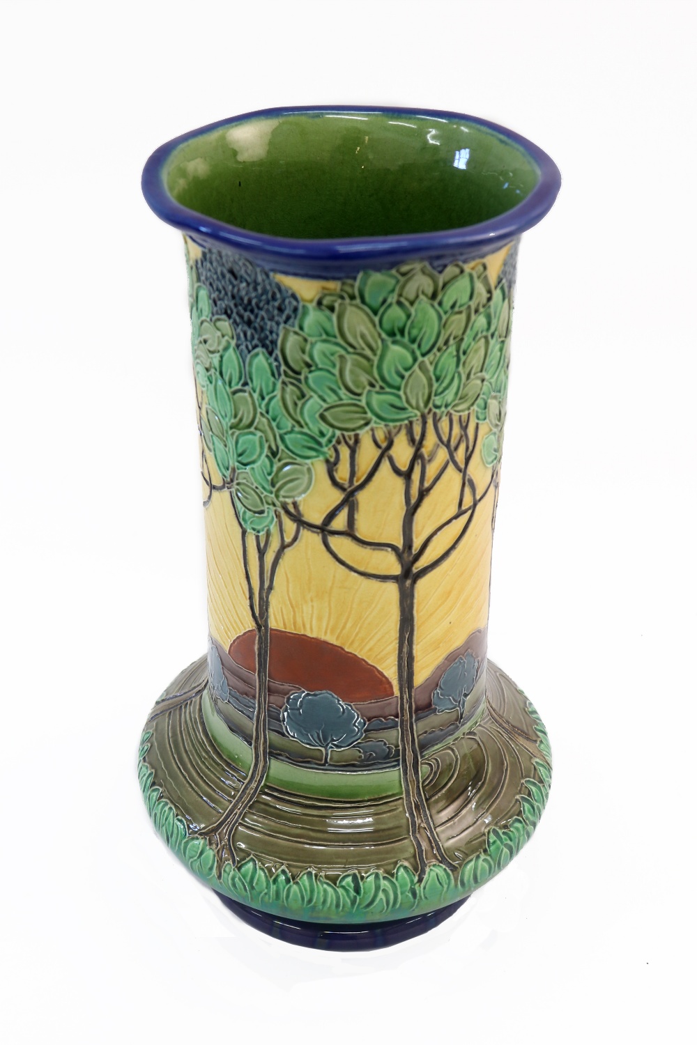 A Burmantofts faience vase, of baluster form, painted with a sunrise in a mountainous landscape,