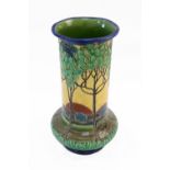 A Burmantofts faience vase, of baluster form, painted with a sunrise in a mountainous landscape,