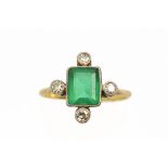 An early 20th century gold, emerald and diamond ring, centred with an emerald-cut emerald approx. 0.